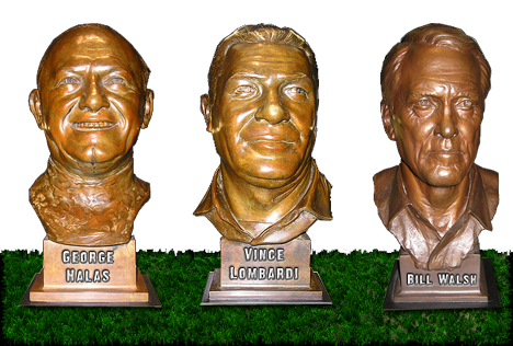 Hall of Fame busts of legendary football coaches Halas, Lombardi, and Walsh